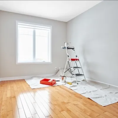 Finished room with fresh paint and roller on ladder